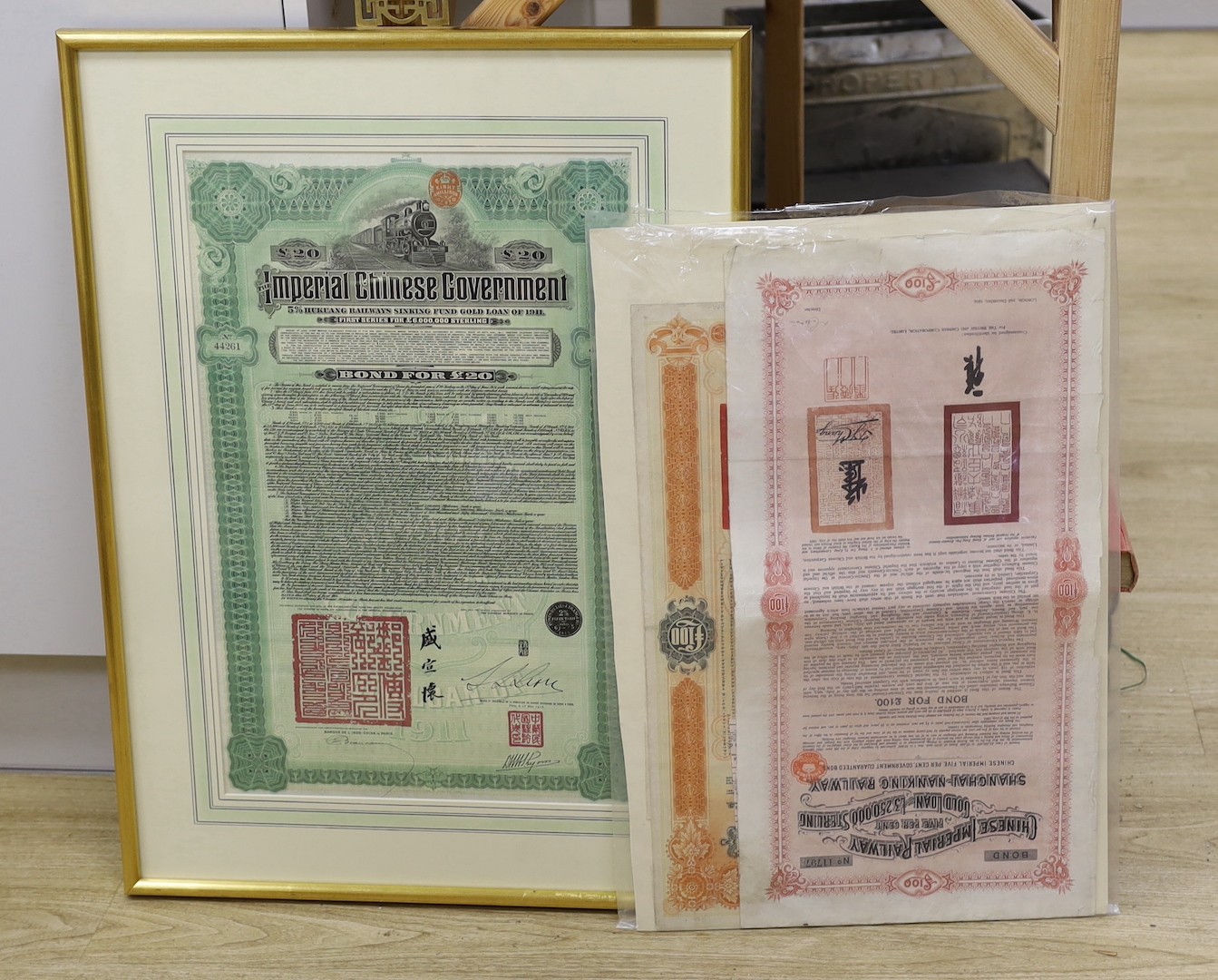 Chinese imperial bonds, including Imperial Chinese government £20 railways sinking fund gold loan of 1911, framed Chinese Imperial Railway 5% government guaranteed bond 1904, some coupons attached and Railway loan bond f